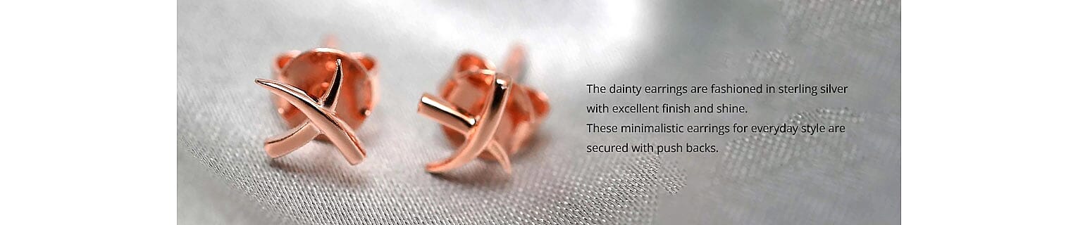 The dainty earrings are fashioned Banner