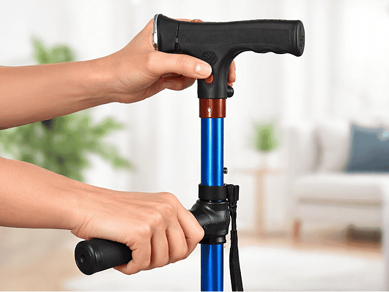 Hands gripping the dual-handle cane