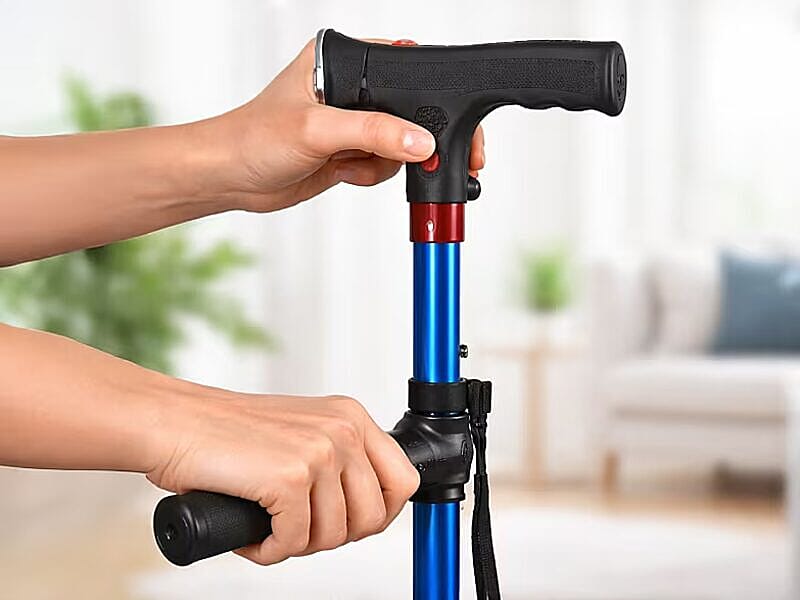 Hands gripping the dual-handle cane