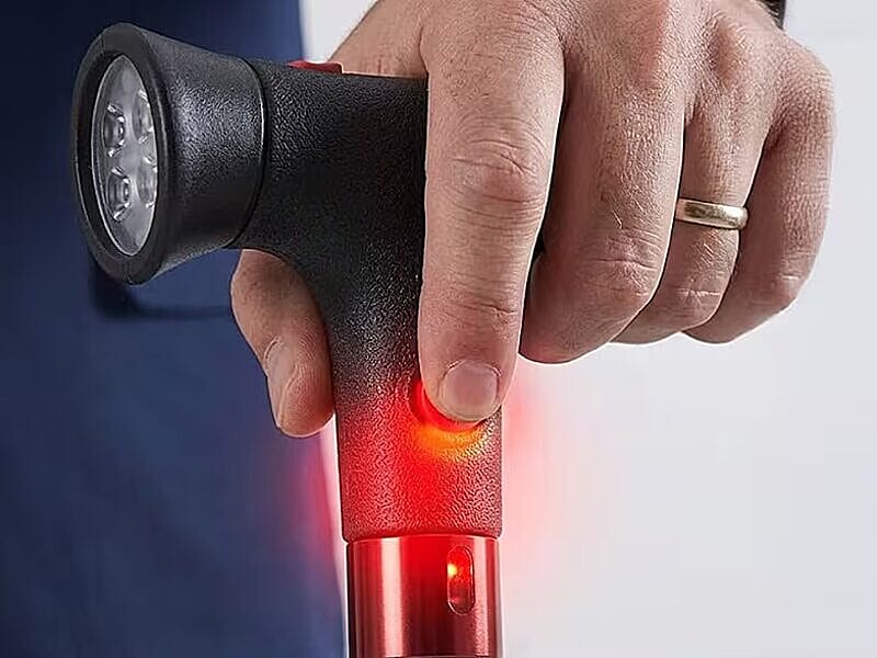 Hand pressing SOS button glowing red