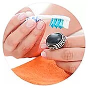 Using a toothbrush to clean jewelry.