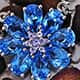 Electric blue topaz floral pendant with chain.