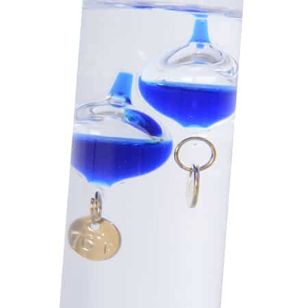 Galileo thermometer with colorful glass bubbles in liquid giving