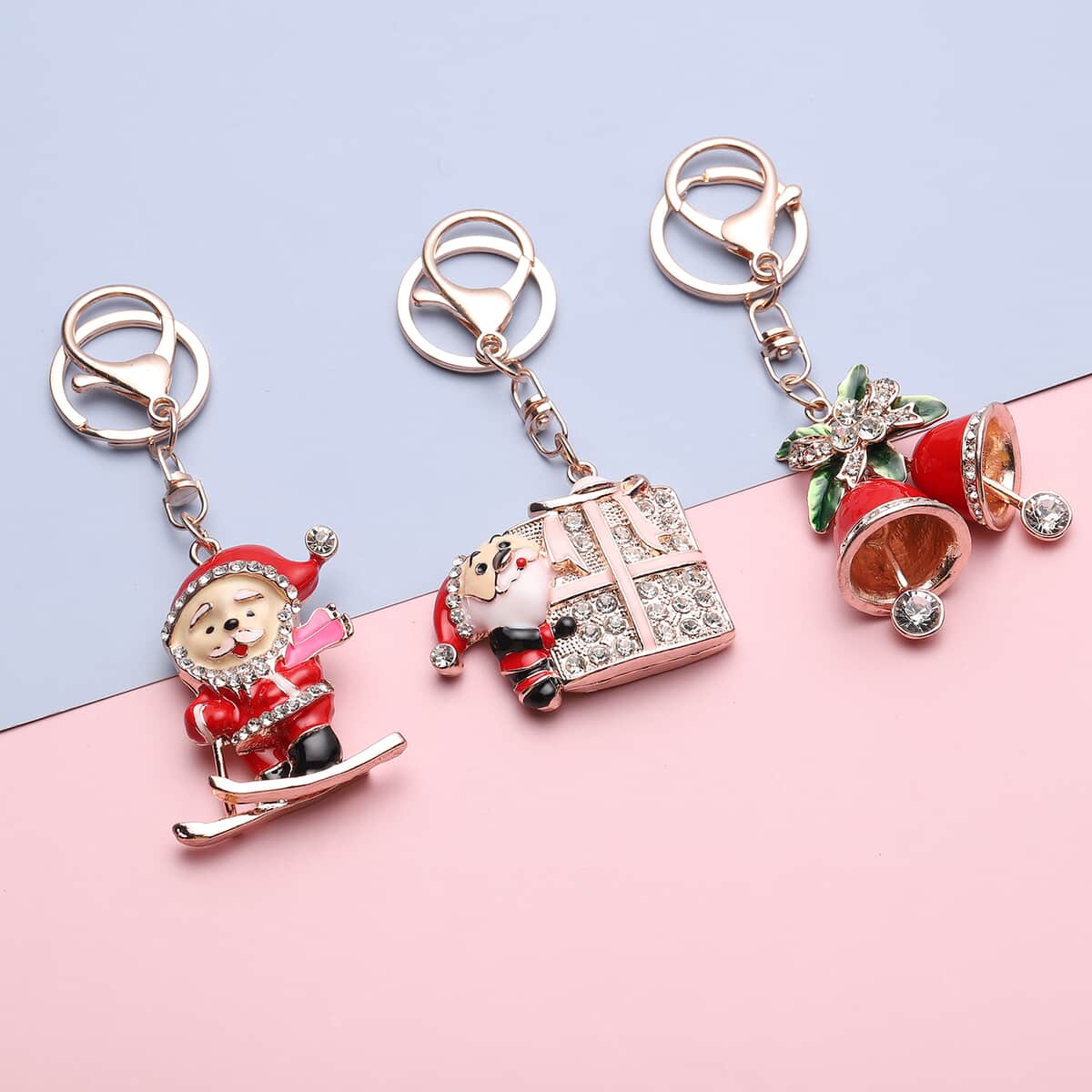 Set of 3 Multi Color Austrian Crystal, Enameled Skiing Santa, Jingle Bells & Christmas Present Keychain in Rosetone image number 1