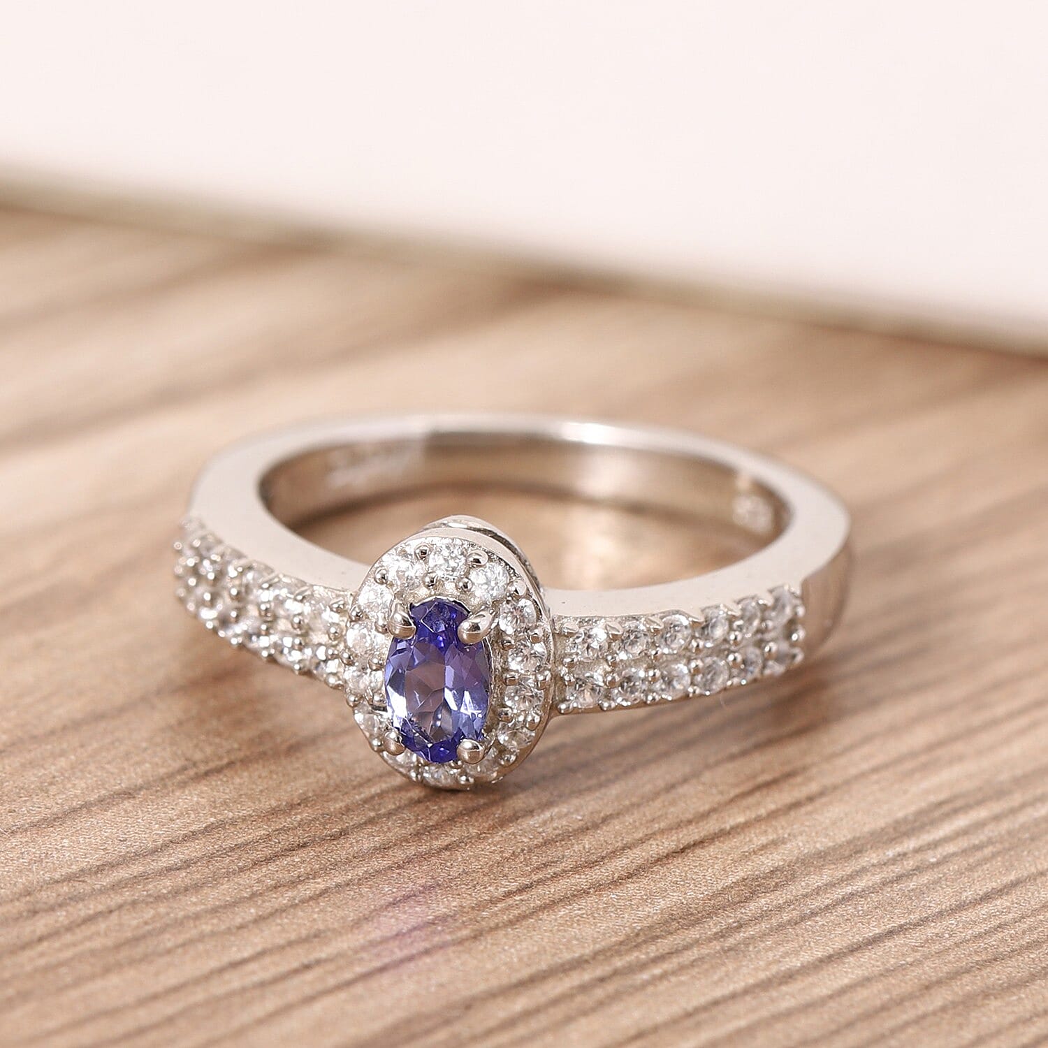 AAA Tanzanite and Zircon Halo Ring in Platinum Over Sterling Silver (Size 10.0) 0.65 ctw