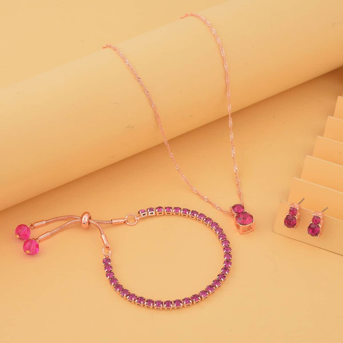 Fuchsia Austrian Crystal and Purple Glass Bracelet (6-9In), Stud Earrings and Pendant Necklace 20-22 Inches in Rosetone image number 1
