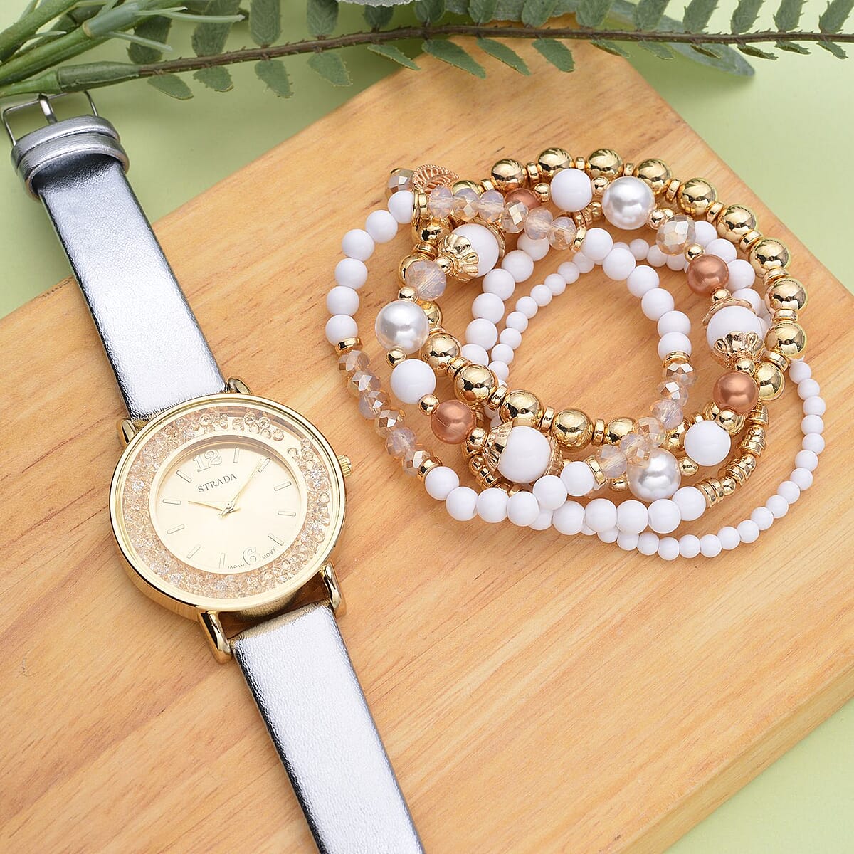 Strada Champagne Crystal Japanese Movement Watch with Silver Faux Leather Strap (40mm) (5.25-7In) and Set of 5 White with Multi Beaded Stretch Bracelet image number 1
