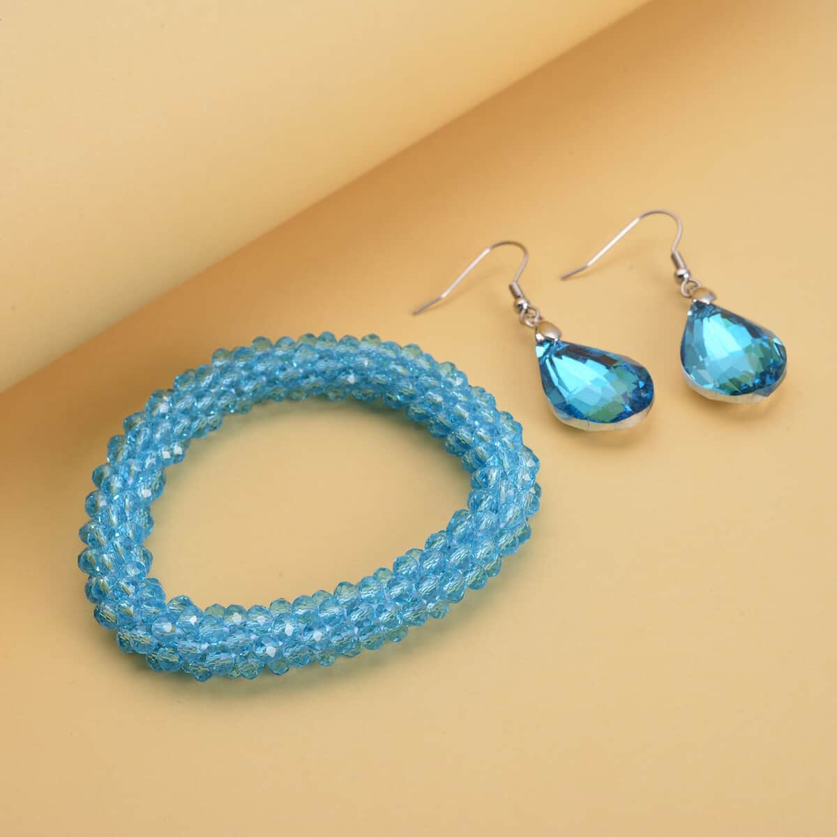Simulated Blue Topaz Beaded Stretch Bracelet and Drop Earrings in Silvertone image number 1
