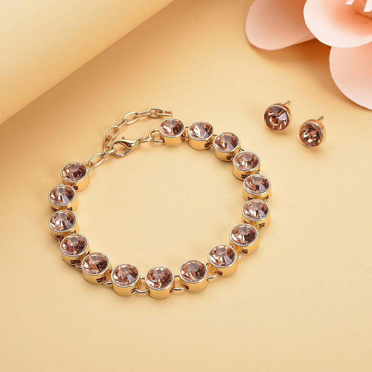 Peach Austrian Crystal Tennis Bracelet (7.50-9.50In) and Stud Earrings in Goldtone image number 1