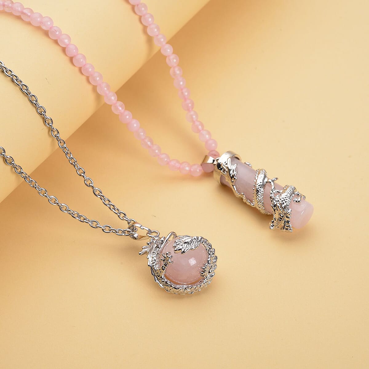 Galilea Rose Quartz Dragon Sphere Pendant Necklace (20 Inches) and Beaded Dragon Scroll Necklace (20-22 Inches) in Silvertone & Stainless Steel 143.00 ctw , Tarnish-Free, Waterproof, Sweat Proof Jewelry image number 1