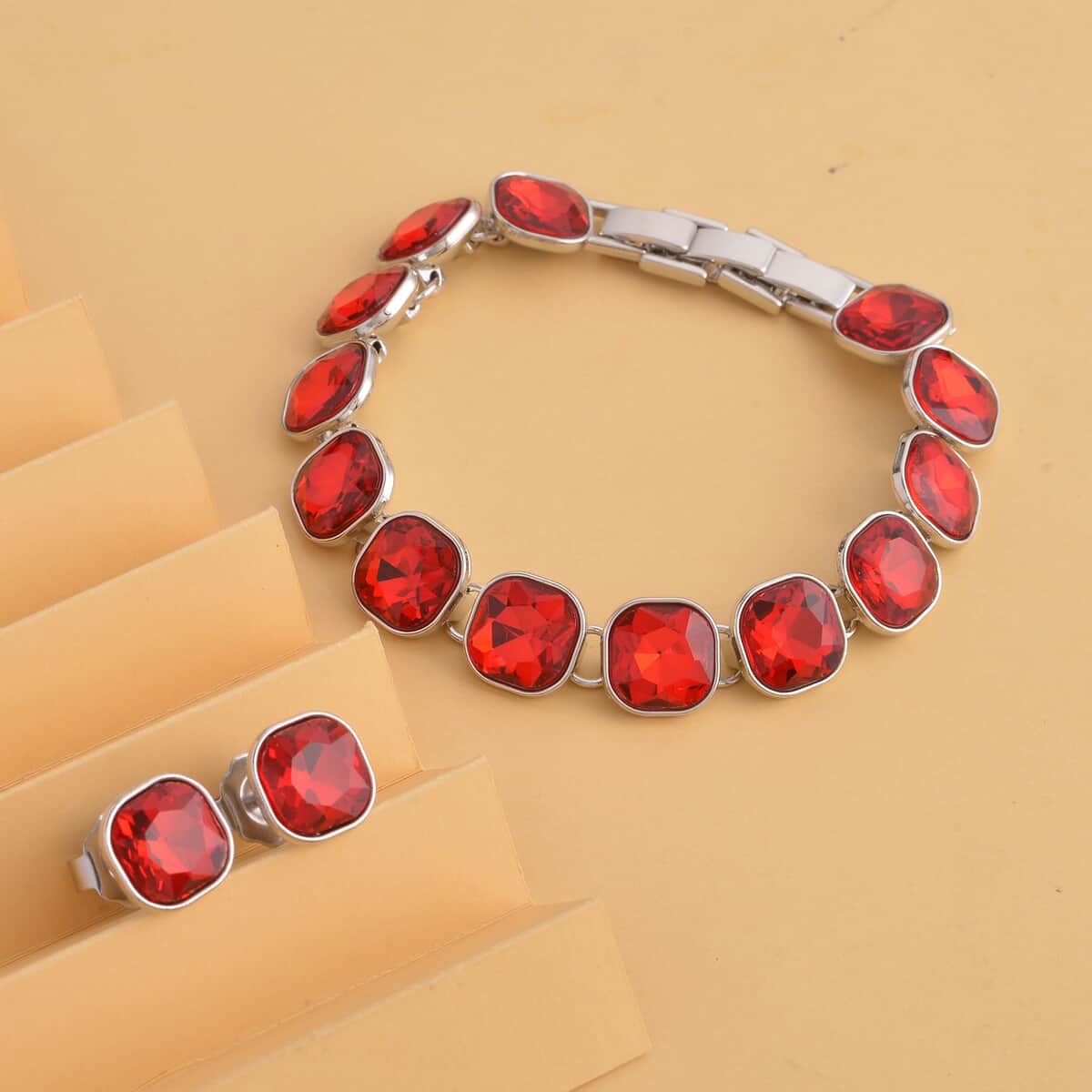 Doorbuster Simulated Ruby Tennis Bracelet (7-8In) and Stud Earrings in Silvertone image number 1