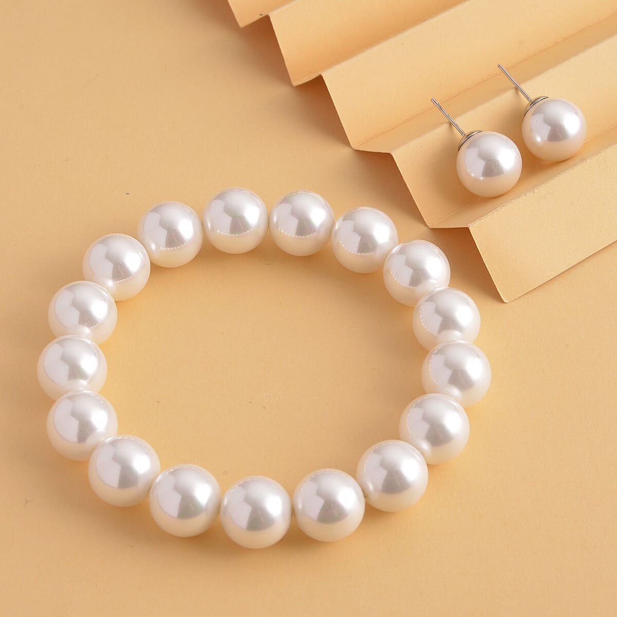 Doorbuster White Shell Pearl Stretch Bracelet and Stud Earrings in Stainless Steel image number 1