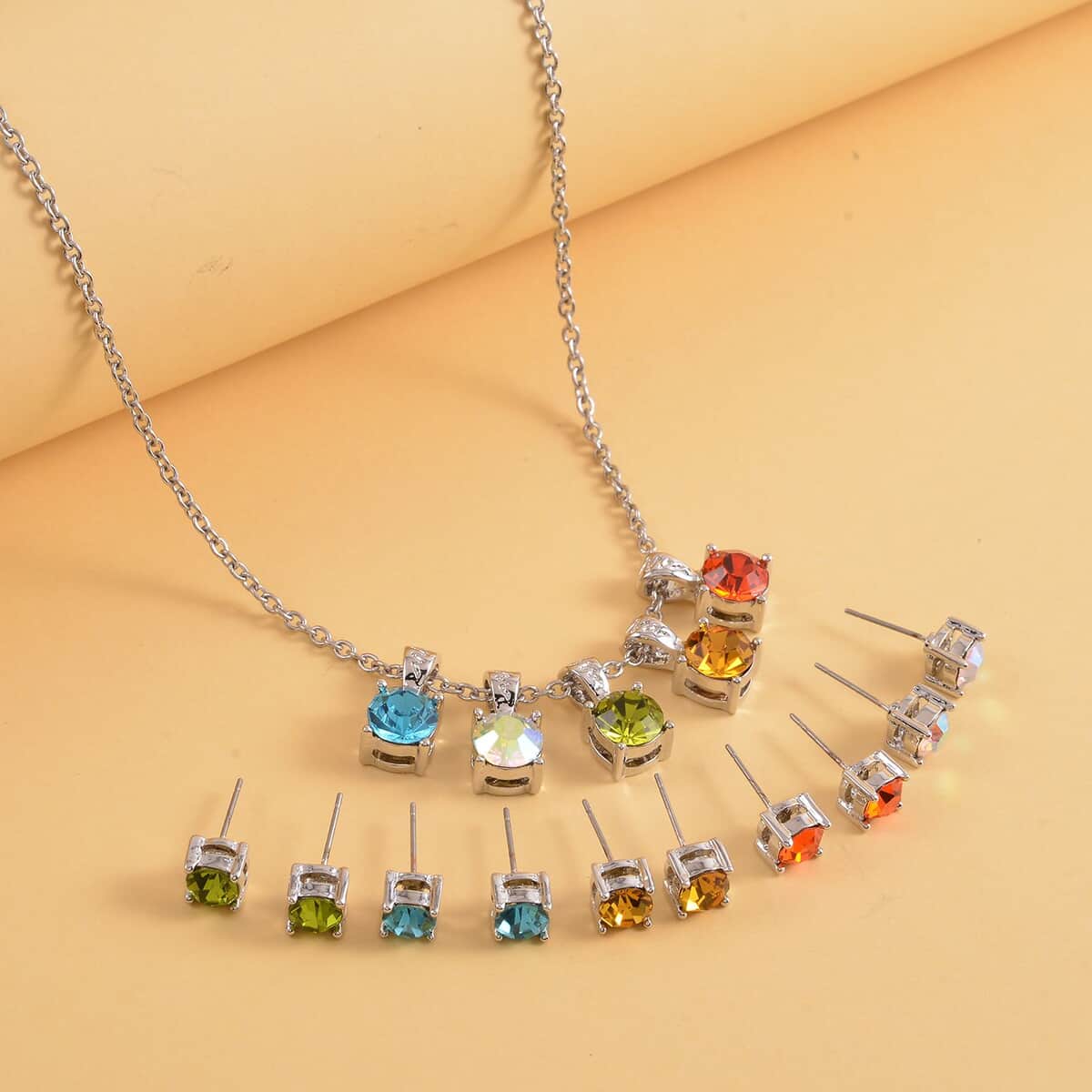 Multi Color Austrian Crystal 5pcs Solitaire Stud Earrings and 5pcs Pendants With Necklace 20 Inches in Silvertone and Stainless Steel image number 1