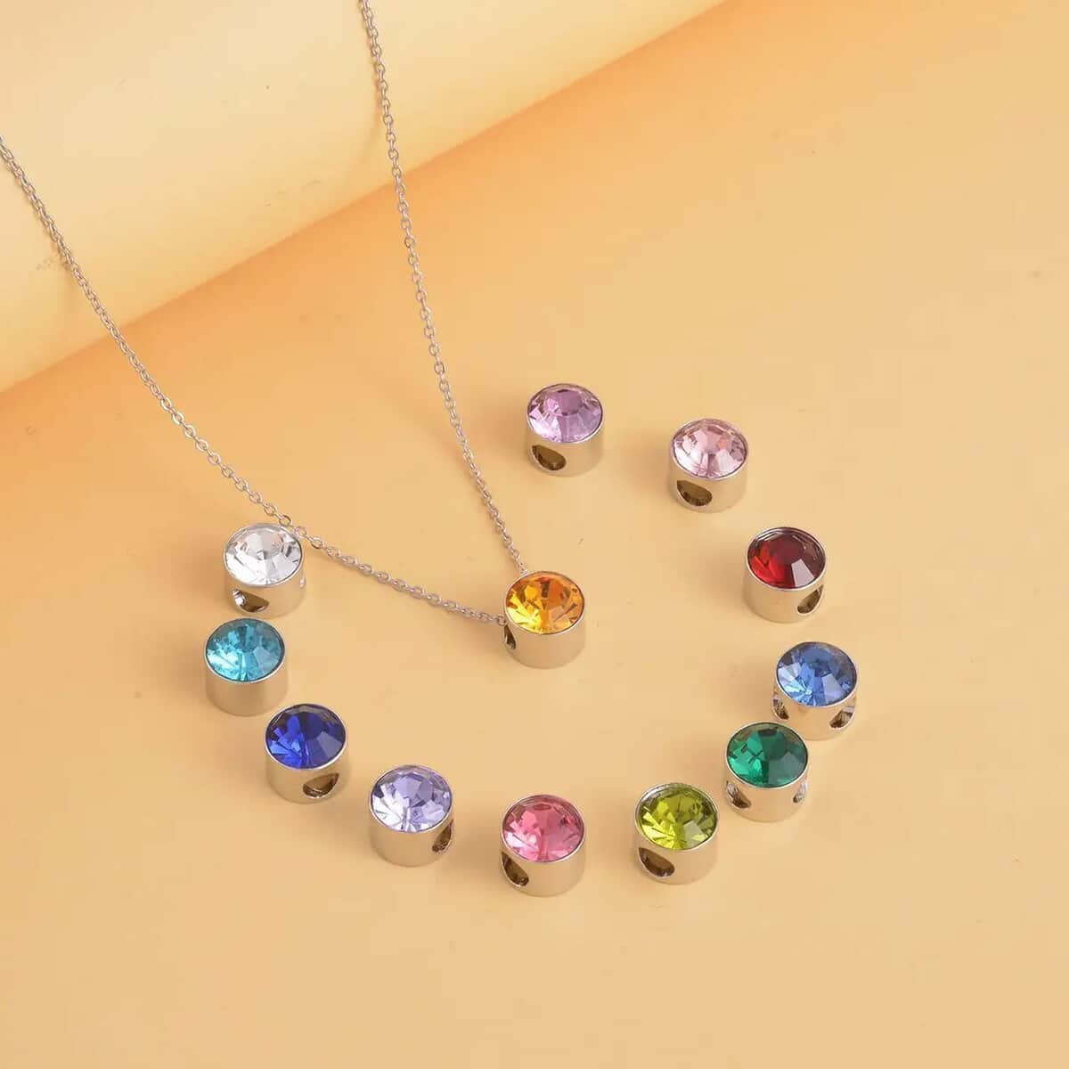 Multi Color Austrian Crystal 12 Interchangeable Pendants in Silvertone with Stainless Steel Necklace 20 Inches  image number 1