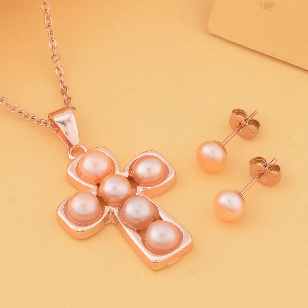 Peach Freshwater Pearl Stud Earrings and Cross Pendant Necklace (20 Inches) in Rosetone & ION Plated RG Stainless Steel | Tarnish-Free, Waterproof, Sweat Proof Jewelry image number 1