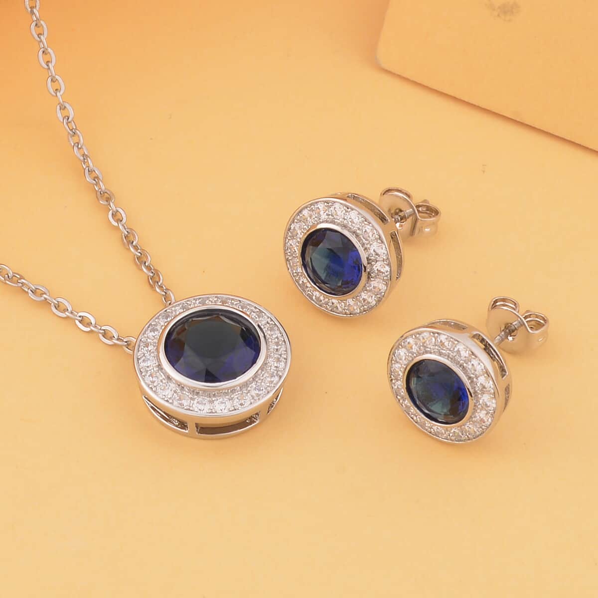 Simulated Blue Sapphire, Simulated White Diamond Halo Pendant Necklace 20 Inches and Stud Earrings in Silvertone 7.10 ctw image number 1