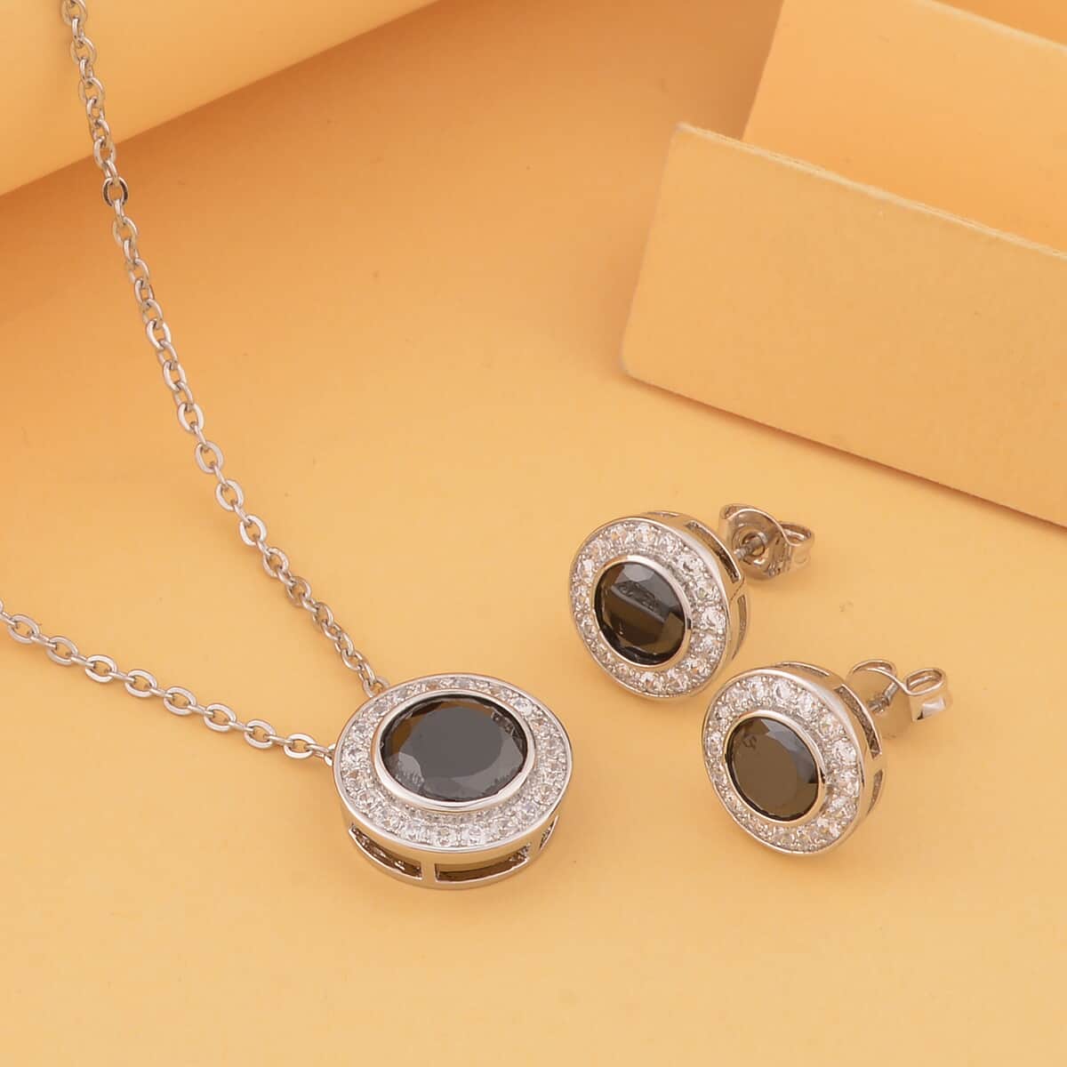 Simulated Black and White Diamond Halo Pendant Necklace 20 Inches and Stud Earrings in Silvertone 7.25 ctw image number 1