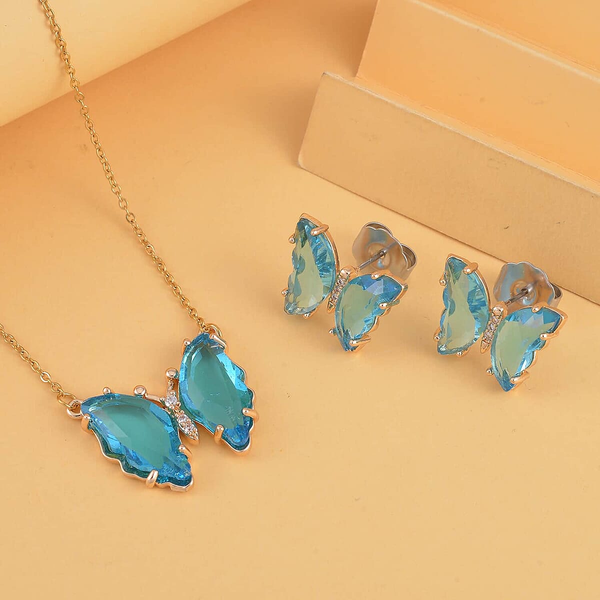 Simulated Sky Blue Topaz, Simulated Diamond Butterfly Earrings and Necklace (20-22 Inches) in Goldtone image number 1
