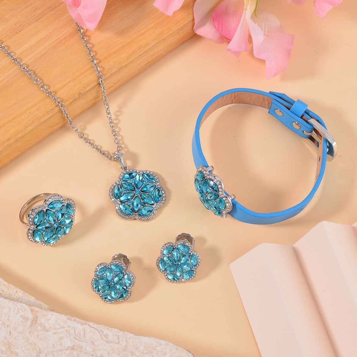 Sky Blue Color and White Austrian Crystal, Faux Leather Floral Bracelet (6-8In), Earrings, Ring (Size 6.0) and Pendant Necklace 20-22 Inches In Silvertone image number 1