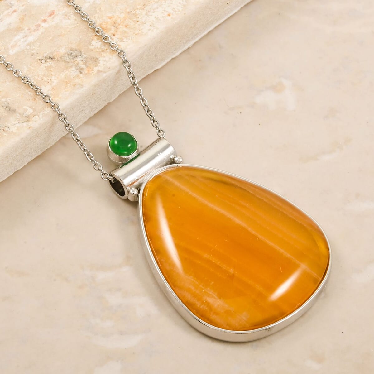 Center Stone Color Varies Inlay Frame Freeform Golden Imperial Calcite 61.00 ctw Pendant in Silvertone with Stainless Steel Necklace (20 Inches) image number 1