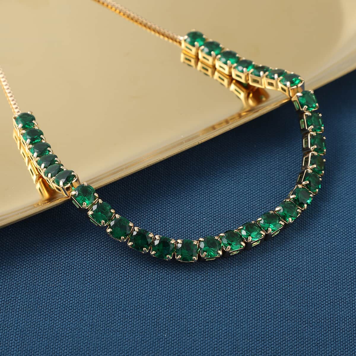 Simulated Green Diamond Bolo Bracelet in Goldtone image number 1