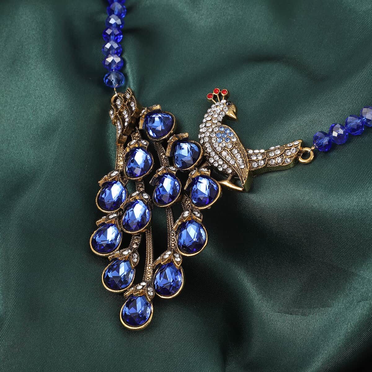 Simulated Blue Magic Color Topa and Blue Austrian Crystal Peacock Necklace 21 Inches in Goldtone image number 1