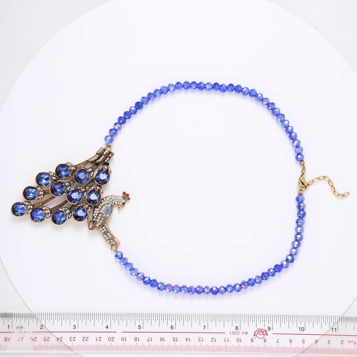 Simulated Blue Magic Color Topa and Blue Austrian Crystal Peacock Necklace 21 Inches in Goldtone image number 2