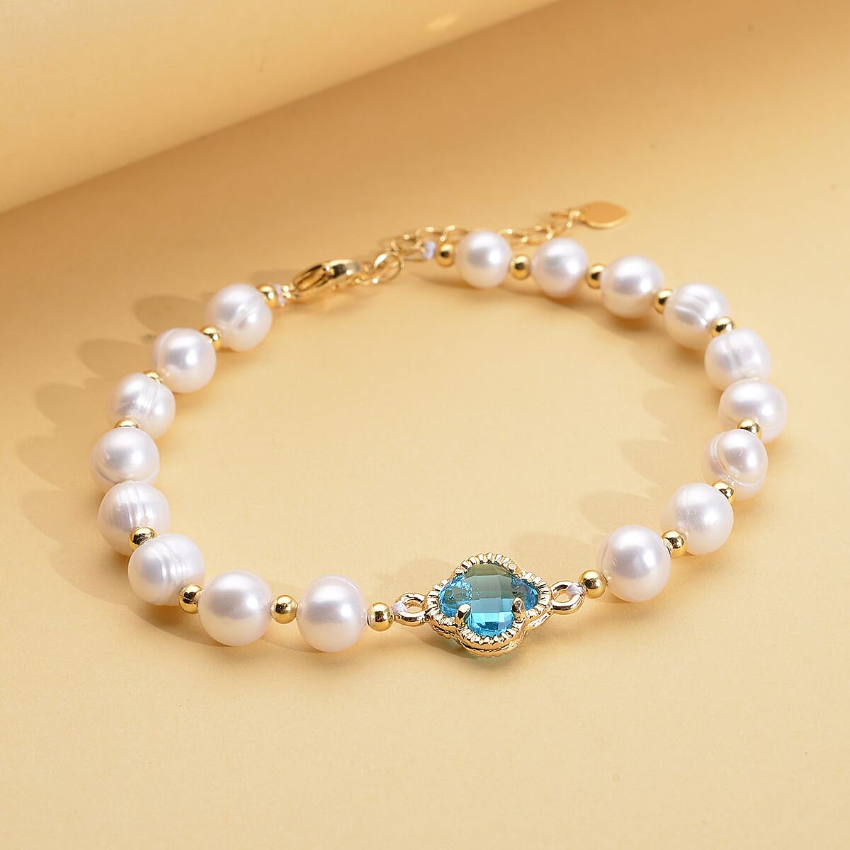 Simulated Blue Sapphire and White Freshwater Pearl Bracelet With Four Clover Leaf Charm in Goldtone Lobster Clasp (7.5-9.5-In) image number 1