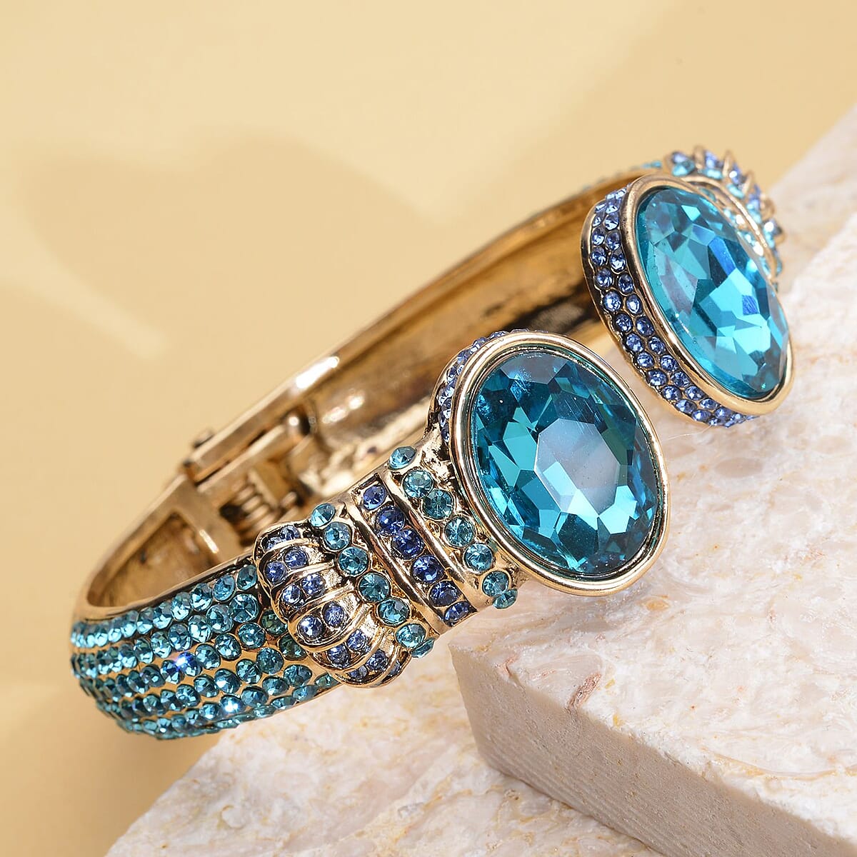 Simulated Aquamarine and Blue Austrian Crystal Openable Bangle Bracelet in Goldtone (7.0 in) image number 1