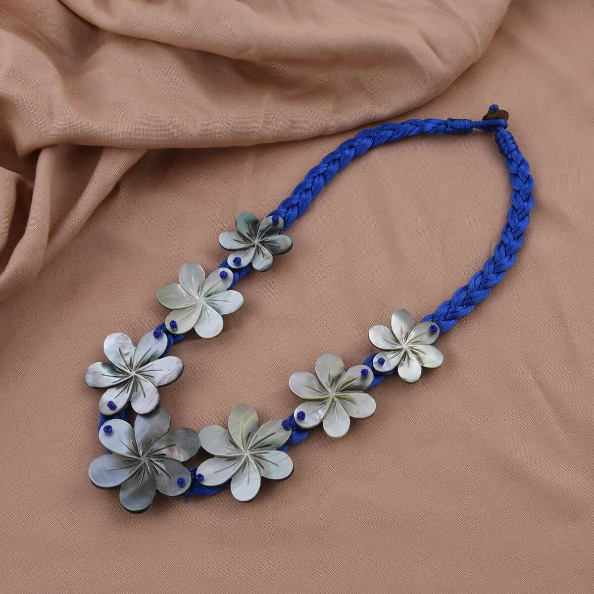 Mother of Pearl Carved Flower and Blue Twisted Nylon Necklace 22 Inches image number 1