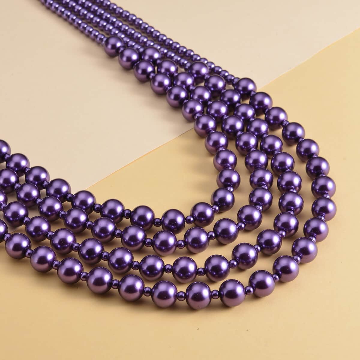 Simulated Purple Pearl 4-12mm Necklace 21-23 Inches in Goldtone image number 1