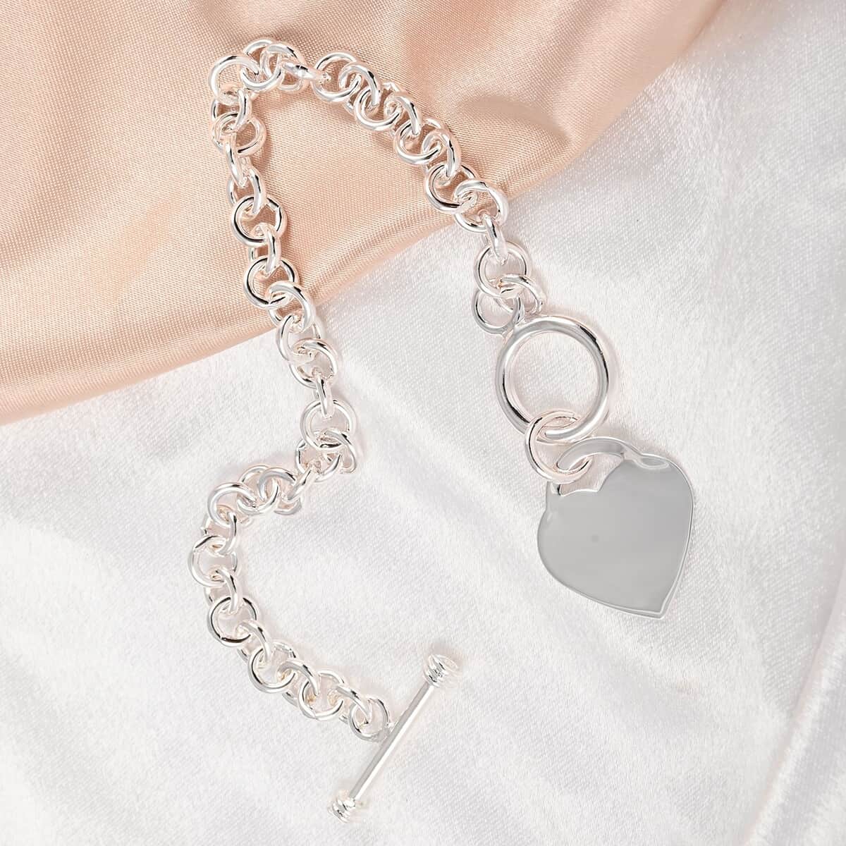 Curb Chain Toggle Lock Bracelet with Heart Charm in Silvertone (7.50 In) image number 1