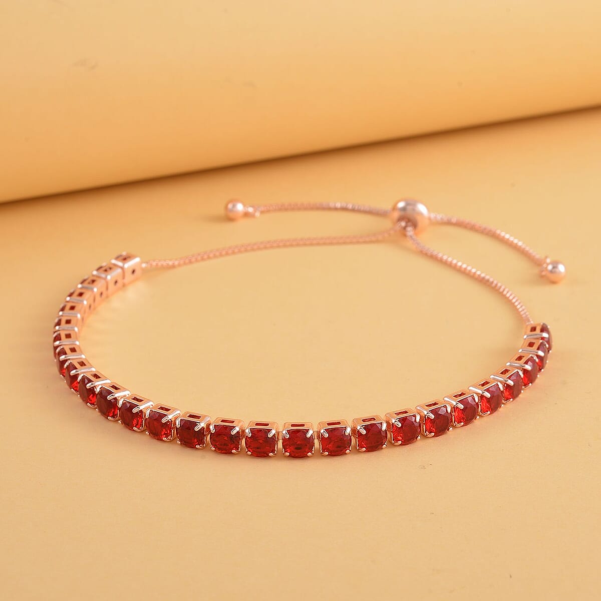 Simulated Red Diamond Tennis Bracelet 6-9Inches with Bolo Slider in Rosetone image number 1