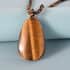 Tiger's Eye Pendant with Beaded Necklace 20 Inches in Rhodium Over Sterling Silver 102.20 ctw image number 1