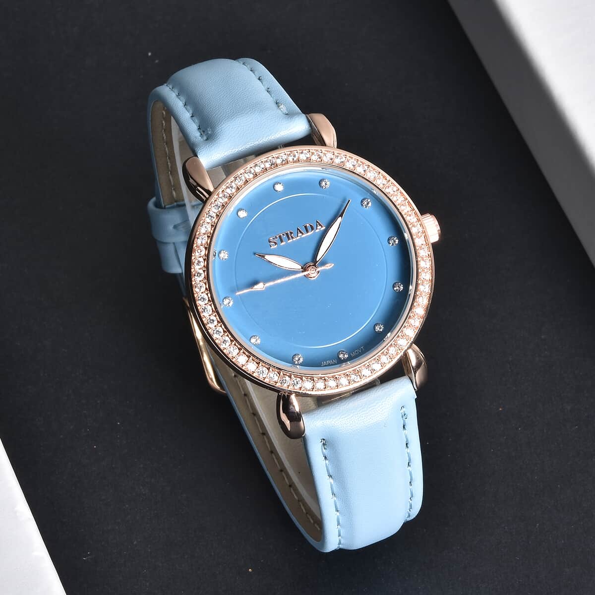Strada Simulated Diamond Japanese Movement Watch in Rosetone with Blue Faux Leather Strap 0.50 ctw image number 1