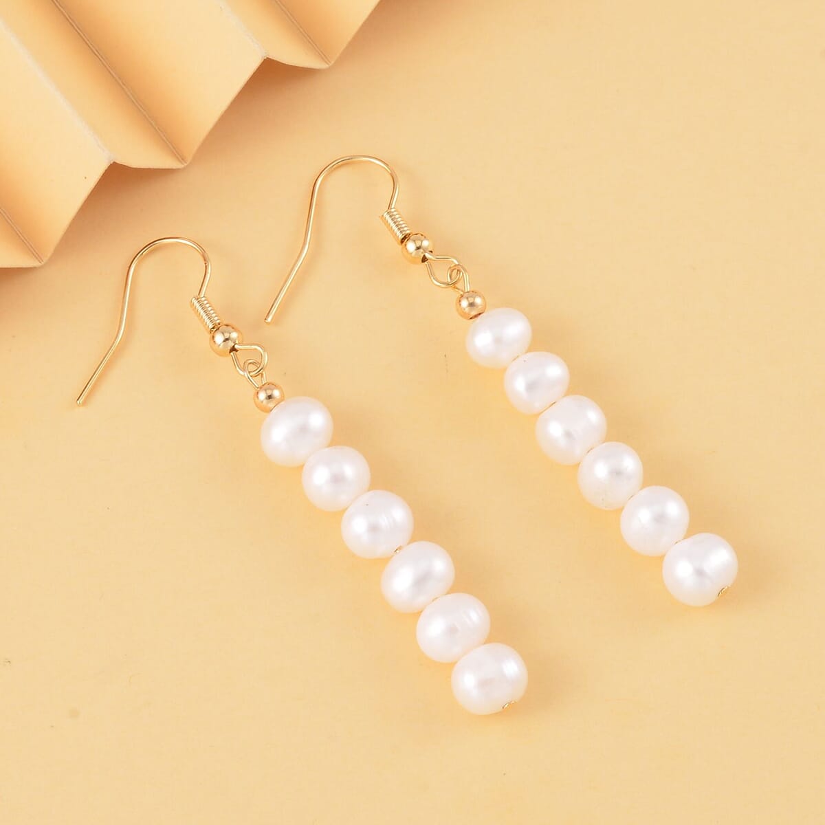 White Freshwater Pearl 5-7mm Dangle Earrings in Goldtone image number 1