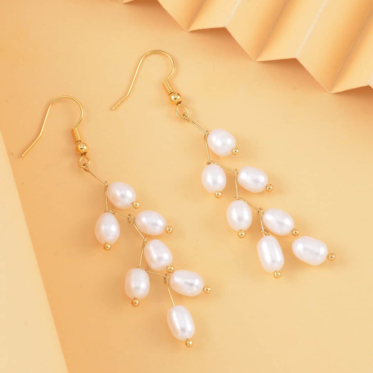 White Freshwater Pearl Dangle Earrings in Goldtone image number 1