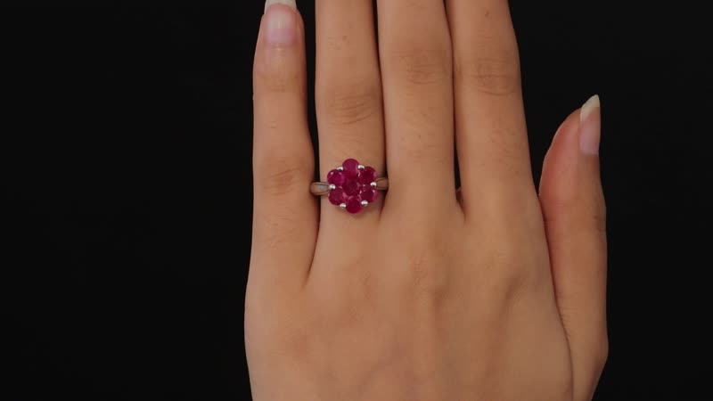 Celebrate the beauty of nature with our Niassa ruby floral ring. This enchanting piece, featuring round-shaped rubies arranged in a stunning floral design and set in platinum over sterling