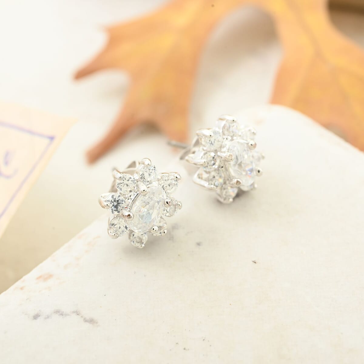 Simulated Diamond Halo Stud Earrings in Silvertone image number 1