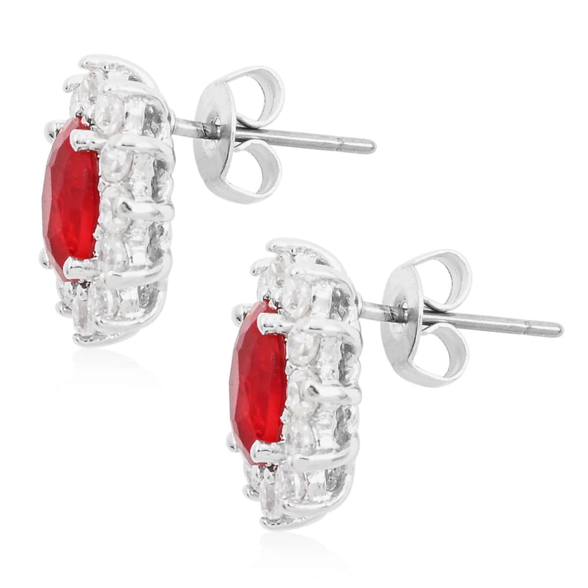 Simulated Red and White Diamond Halo Stud Earrings in Silvertone image number 3