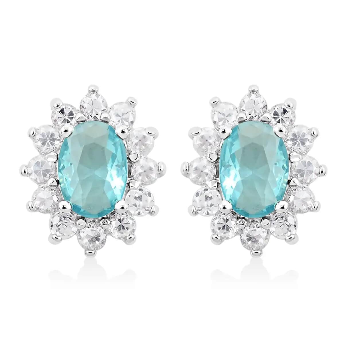 Simulated Blue and White Diamond Halo Stud Earrings in Silvertone image number 0