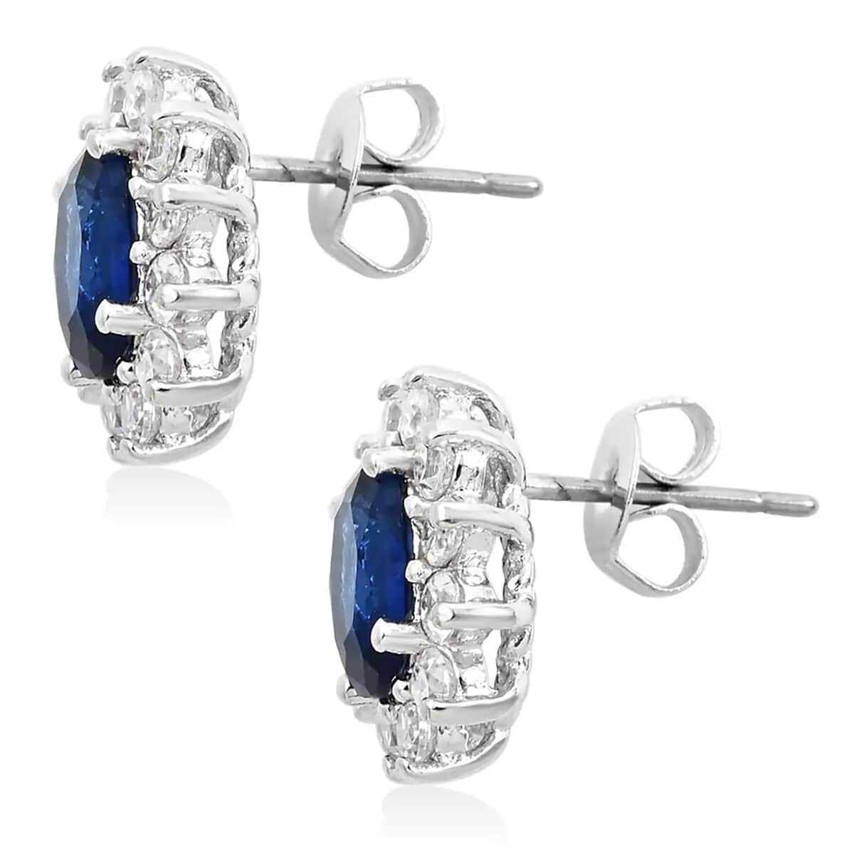 Simulated Blue and White Diamond Halo Stud Earrings in Silvertone image number 8