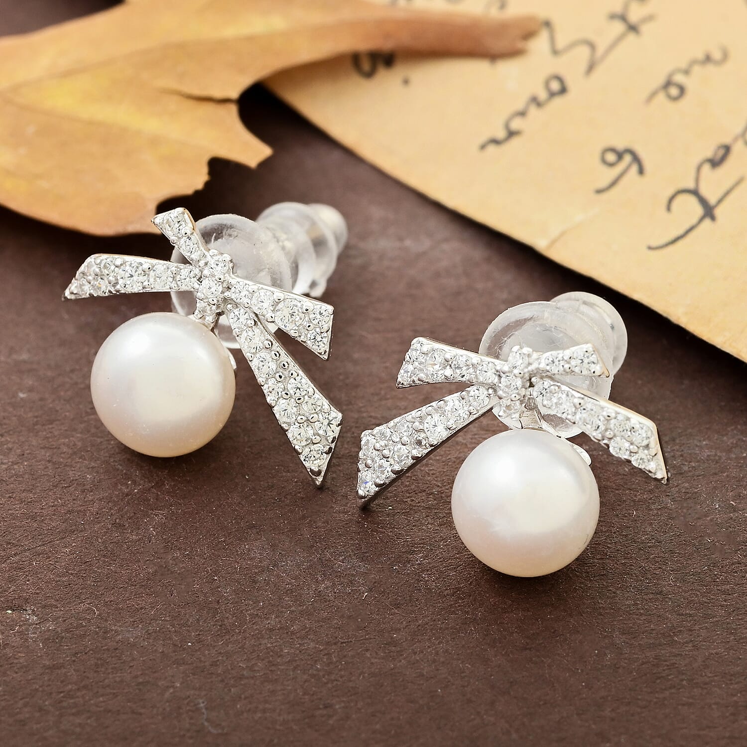 Freshwater Pearl and Simulated Diamond Bow Stud Earrings in Rhodium Over Sterling Silver 0.25 ctw