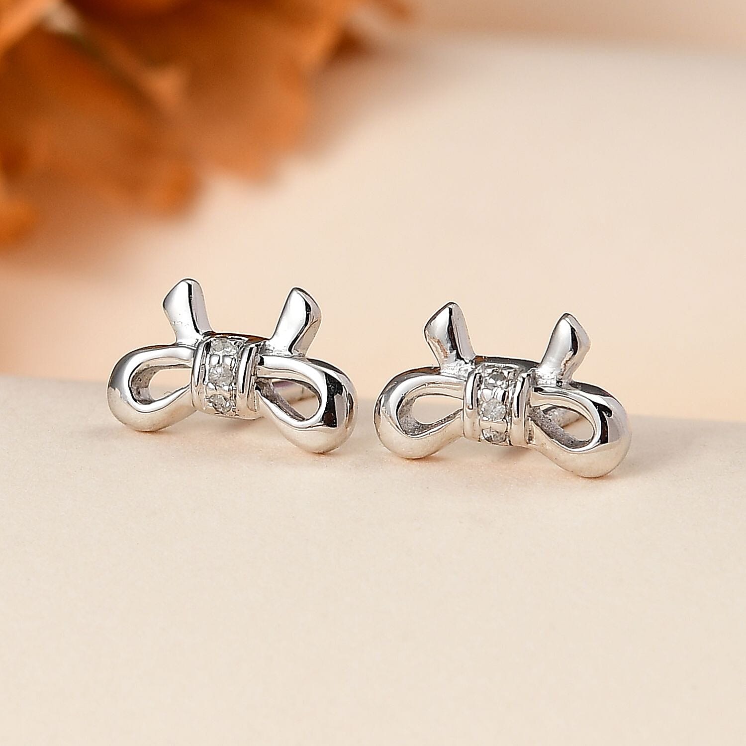 Diamond Accent Bow Knot Stud Earrings in Platinum Over Sterling Silver
