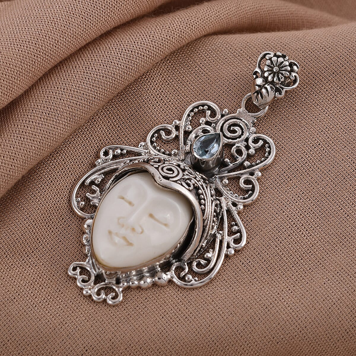 Bali Goddess Carved Bone and Sky Blue Topaz Pendant in Sterling Silver 10.90 Grams 0.50 ctw image number 1