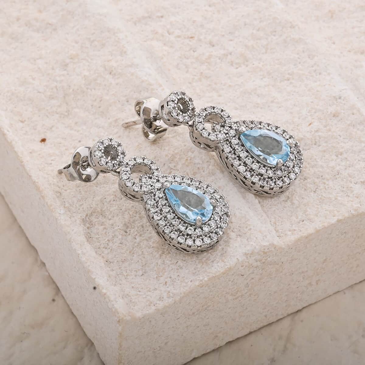 Blue Topaz and Simulated Diamond 3.85 ctw Teardrop Earrings in Silvertone image number 1