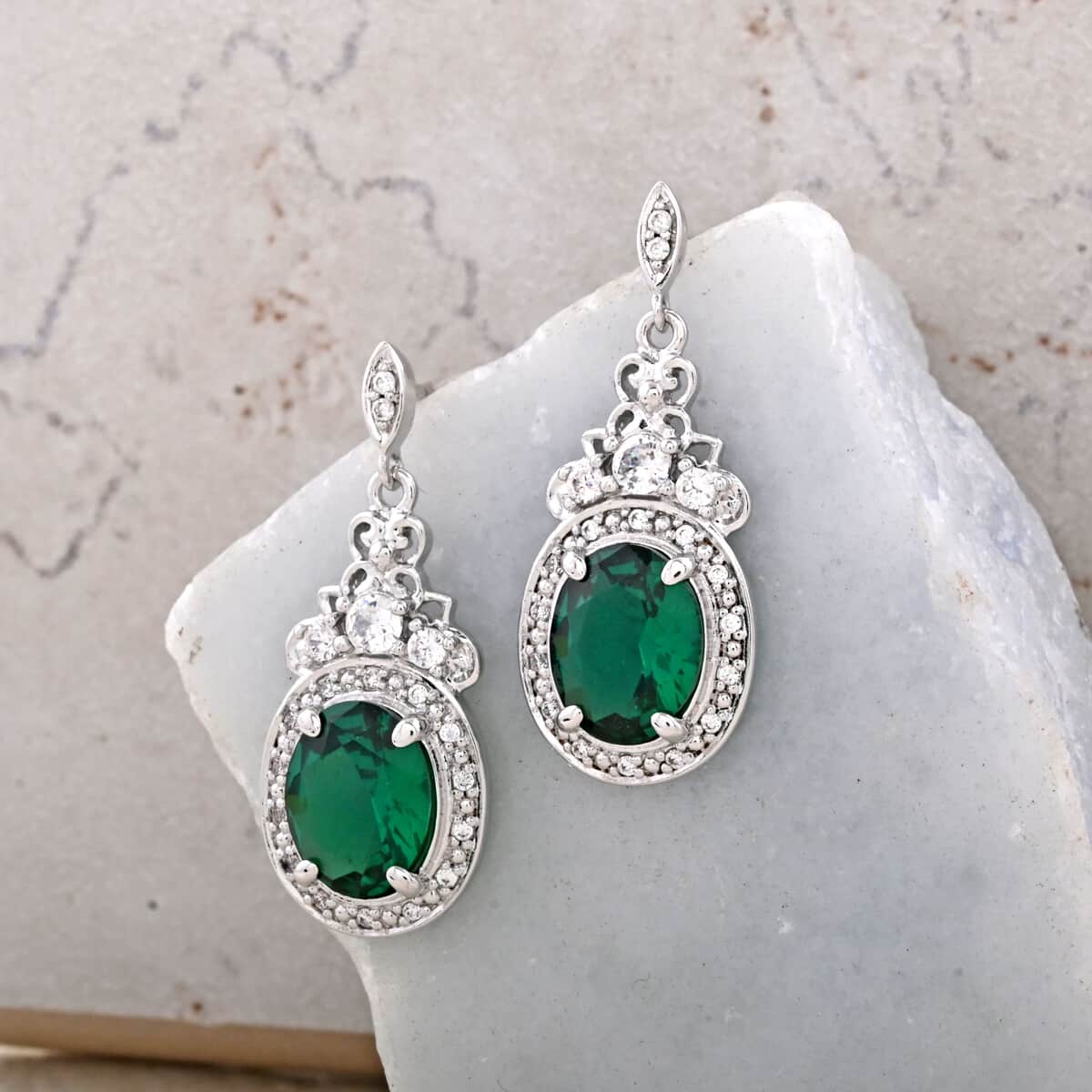 Simulated Emerald and Simulated Diamond 8.75 ctw Earrings in Silvertone image number 1