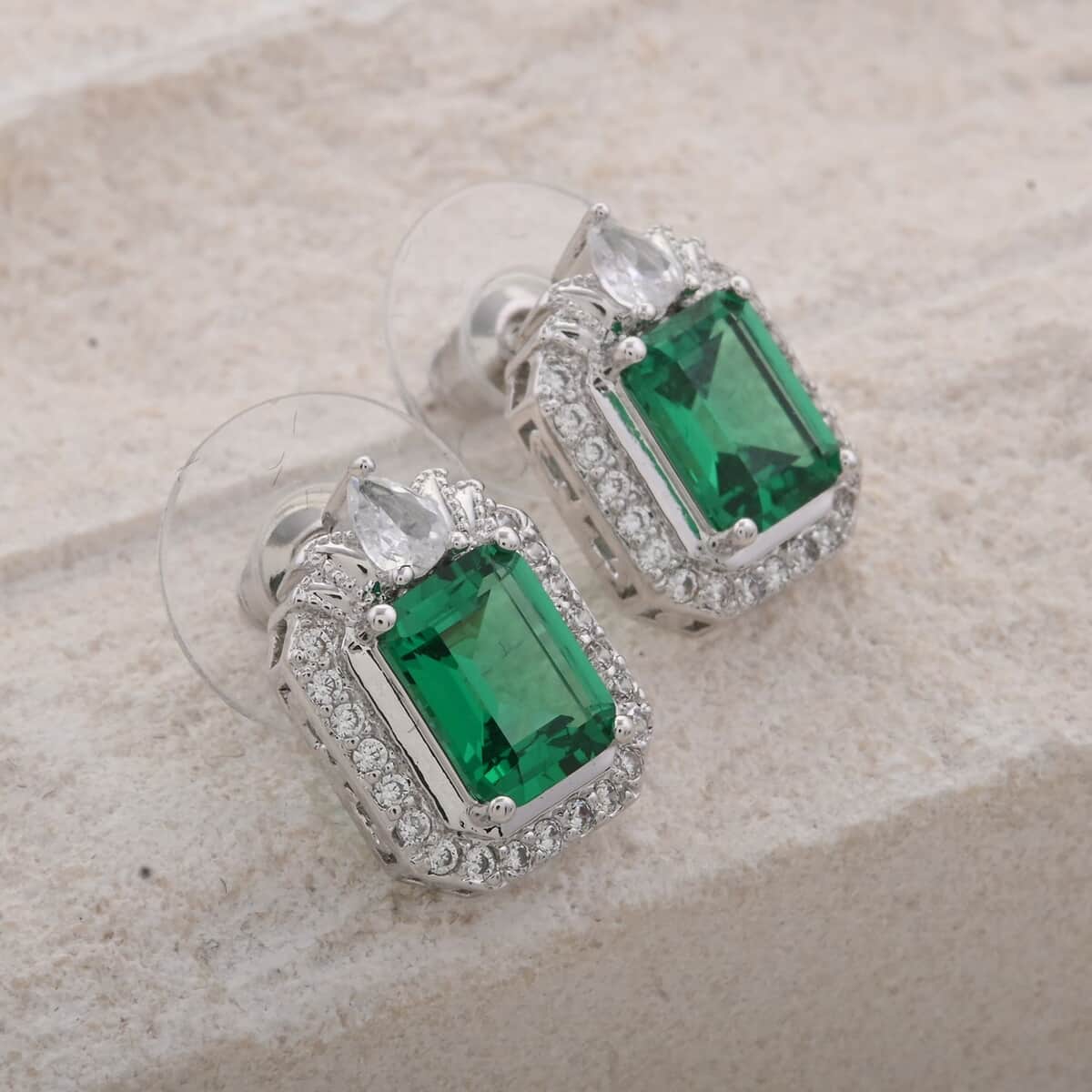 Simulated Emerald and Simulated Diamond 4.35 ctw Earrings in Silvertone image number 1