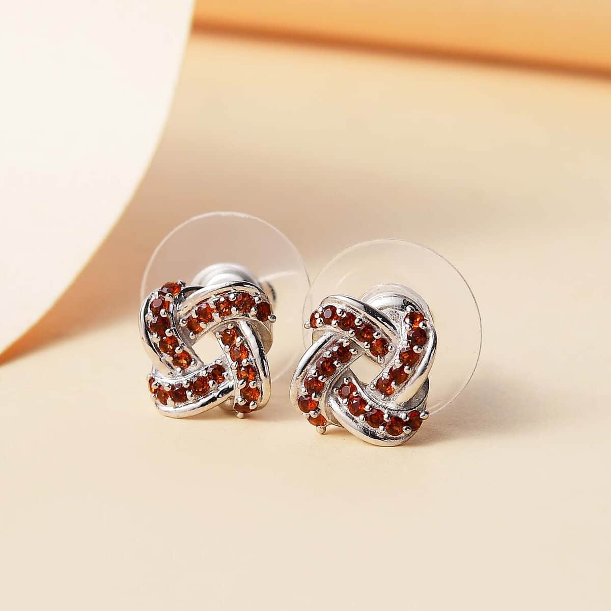 Mozambique Garnet 0.50 ctw Knot Stud Earrings in Rhodium Over Sterling Silver image number 1