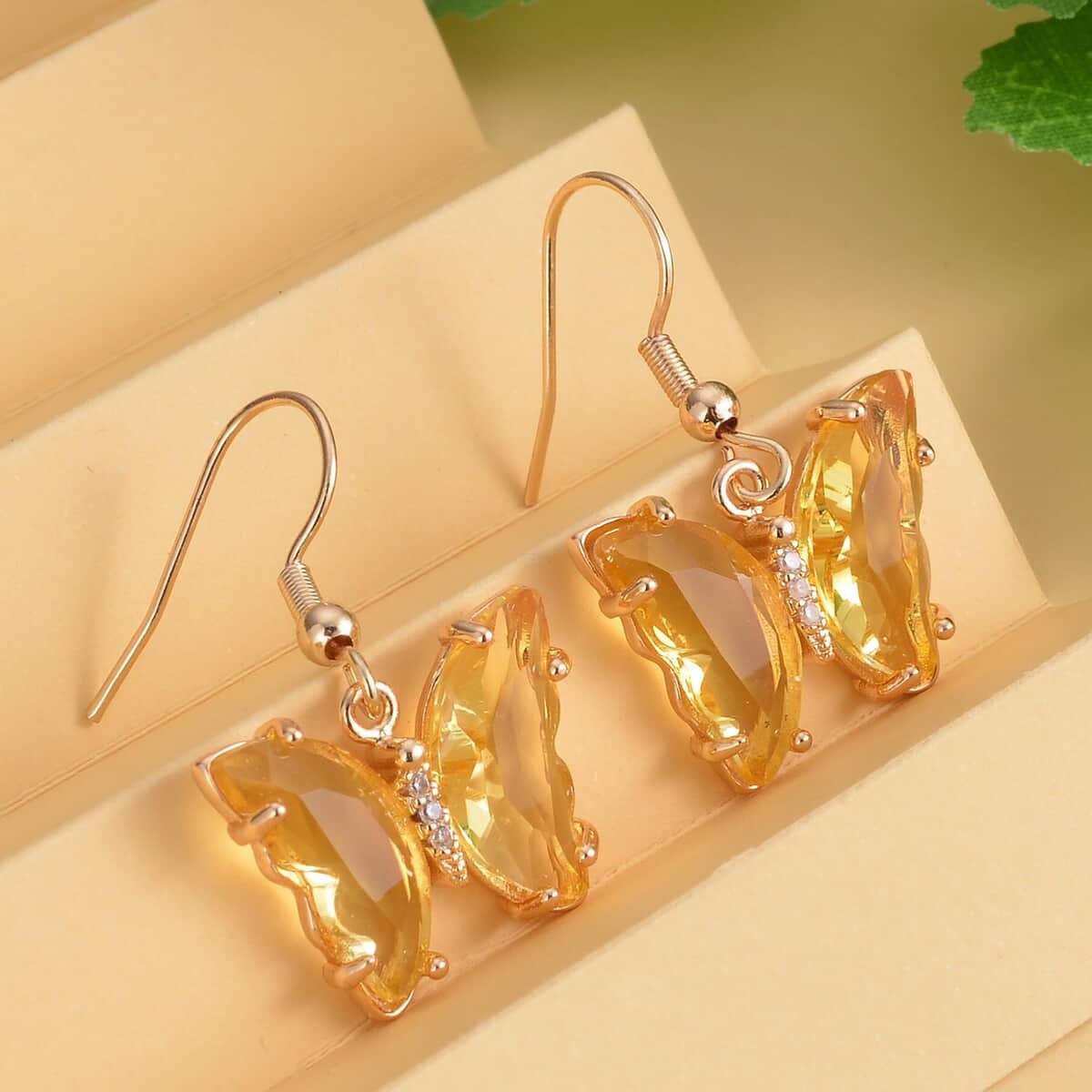 Simulated Yellow Sapphire and Simulated Diamond Butterfly Earrings in Goldtone image number 1